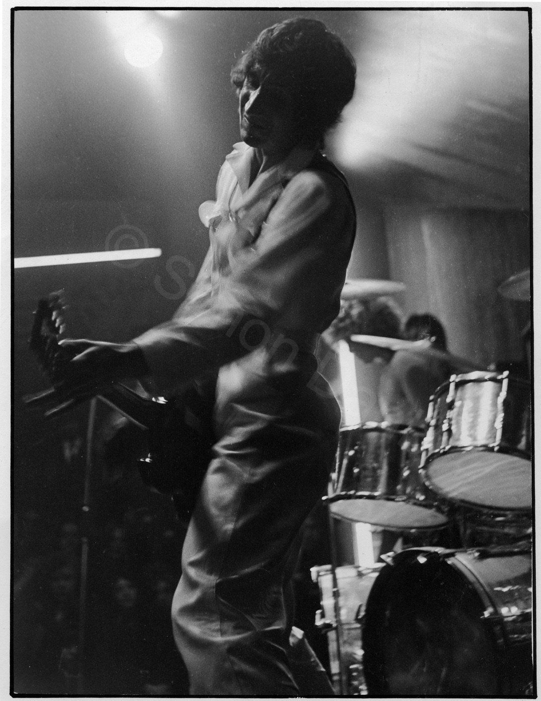 Winter of 1968/9 at the Bay Hotel, Sunderland. John Shaunessy, a photographer from gosforth took me to Sunderland with a borrowed Rollieflex and two rolls of slow film- no flash. This tour was intended to wind The Who up in preparation for the release of Tommy.
Sweat ran freely down the Bay Hotel's black walls and the band grabbed your guts. All this series of photographs were taken behind the speakers, sharing  what space there was with the roadie. All the original negatives wre scratched badly at the lab- who in turn retouched prints and rephotographed them. 
The eyes and fingers have it. This is my favourite rock image.
 Simon Danby 1968